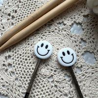 Smiley face needle protectors