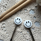 Smiley face needle protectors